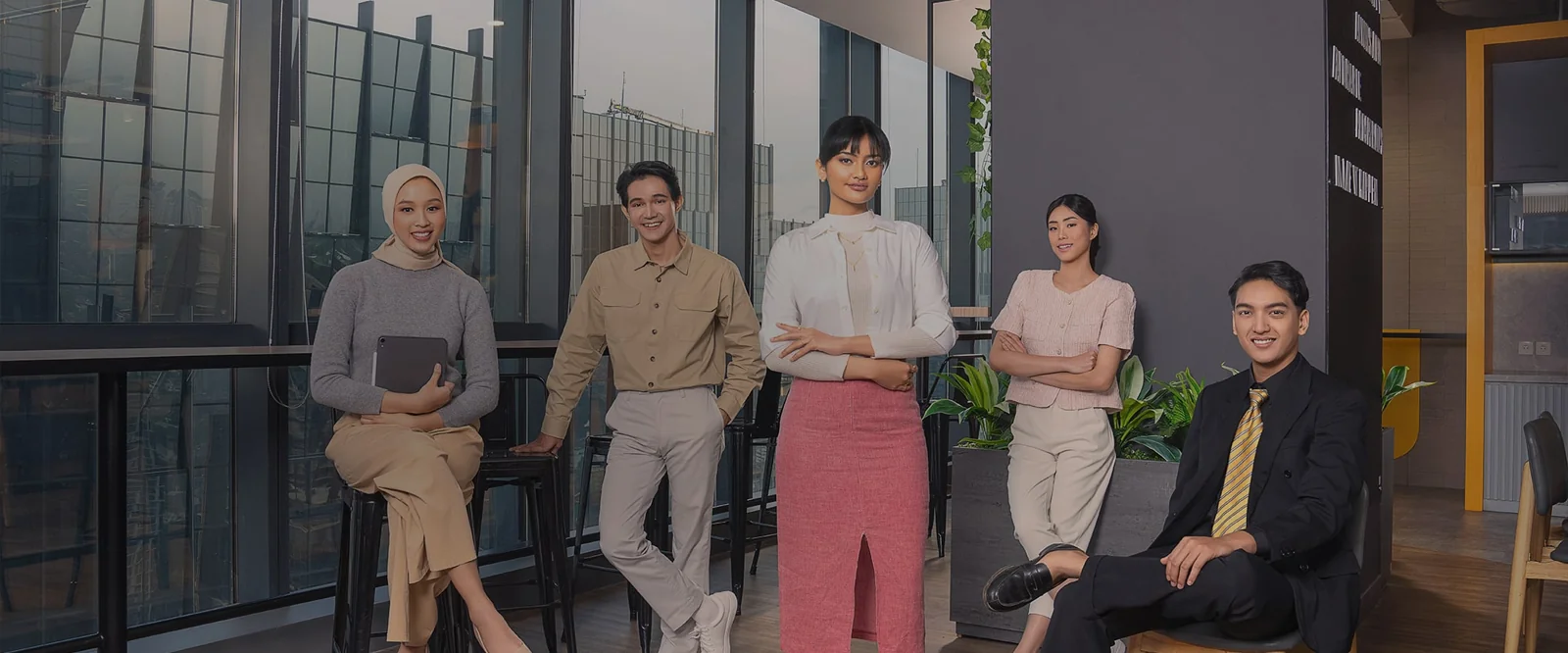 Lima karyawan Bank Neo Commerce berpose di kantor