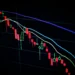 Grafik candlestick pasar saham di layar gelap